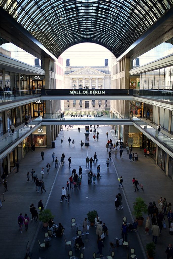 View of the bustling Mall of Berlin with shoppers enjoying a day indoors.